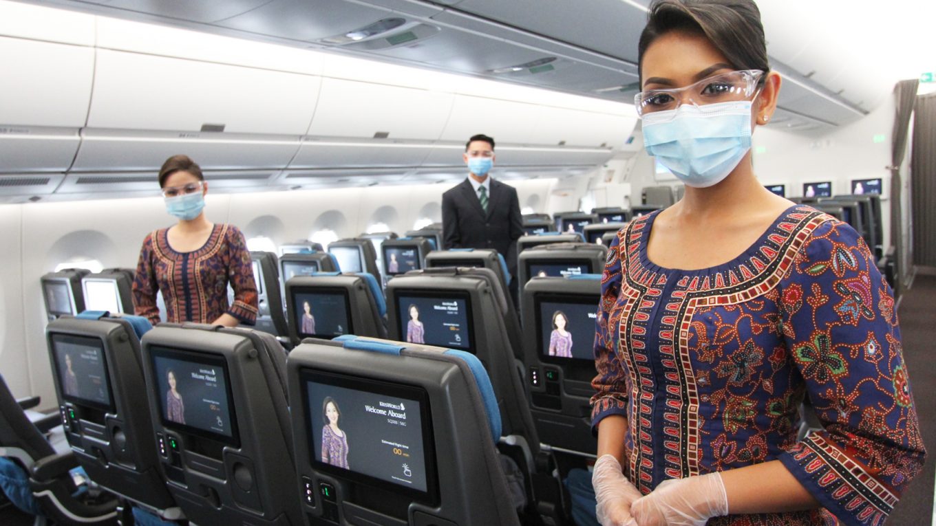 Cabin crew wear masks and goggles when interacting with customers in the cabin
